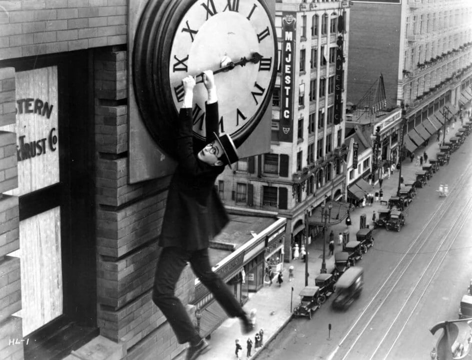 Harold Lloyd hanging from a clock face in Safety Last! 