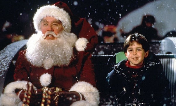 Scott Calvin as Father Christmas in the sleigh with his son Charlie Calvin. Scott is a typical dad involved in the process of writing Christmas films